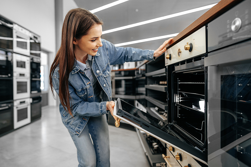 Файл:Young-woman-looking-new-electric-oven-shopping-mall-2000px.jpg